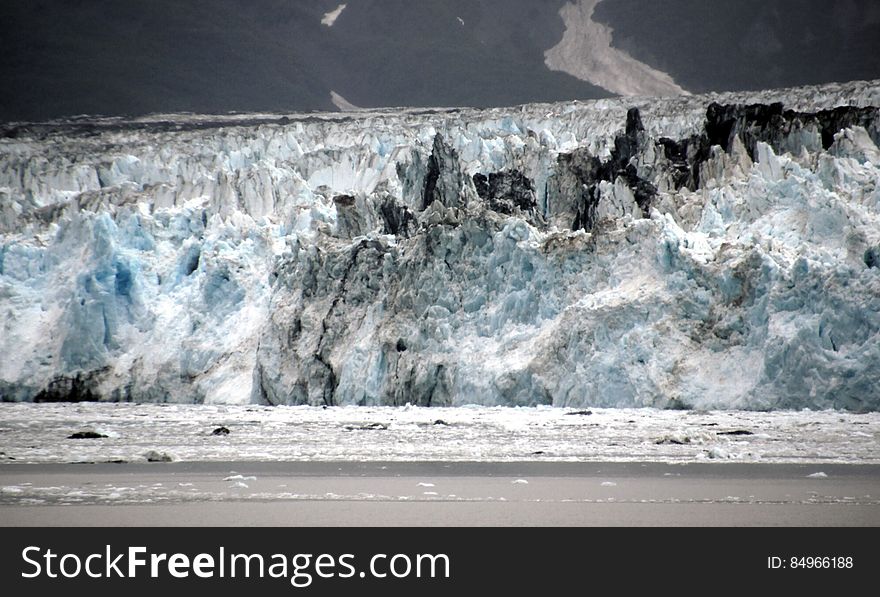 The longest source for Hubbard Glacier originates 122 kilometres &#x28;76 mi&#x29; from its snout and is located at about 61°00′N 140°09′W, approximately 8 kilometres &#x28;5 mi&#x29; west of Mount Walsh with an altitude around 11,000 feet &#x28;3,400 m&#x29;. A shorter tributary glacier begins at the easternmost summit on the Mount Logan ridge at about 18,300 feet &#x28;5,600 m&#x29; at about 60°35′0″N 140°22′40″W. Before it reaches the sea, Hubbard is joined by the Valerie Glacier to the west, which, through forward surges of its own ice, has contributed to the advance of the ice flow that experts believe will eventually dam the Russell Fjord from Disenchantment Bay waters. The longest source for Hubbard Glacier originates 122 kilometres &#x28;76 mi&#x29; from its snout and is located at about 61°00′N 140°09′W, approximately 8 kilometres &#x28;5 mi&#x29; west of Mount Walsh with an altitude around 11,000 feet &#x28;3,400 m&#x29;. A shorter tributary glacier begins at the easternmost summit on the Mount Logan ridge at about 18,300 feet &#x28;5,600 m&#x29; at about 60°35′0″N 140°22′40″W. Before it reaches the sea, Hubbard is joined by the Valerie Glacier to the west, which, through forward surges of its own ice, has contributed to the advance of the ice flow that experts believe will eventually dam the Russell Fjord from Disenchantment Bay waters.