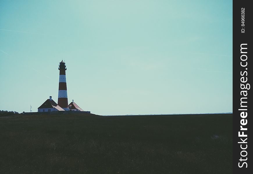Lighthouse On Open Landscape
