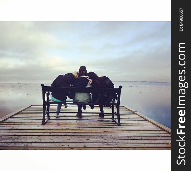 Friends on bench at lake