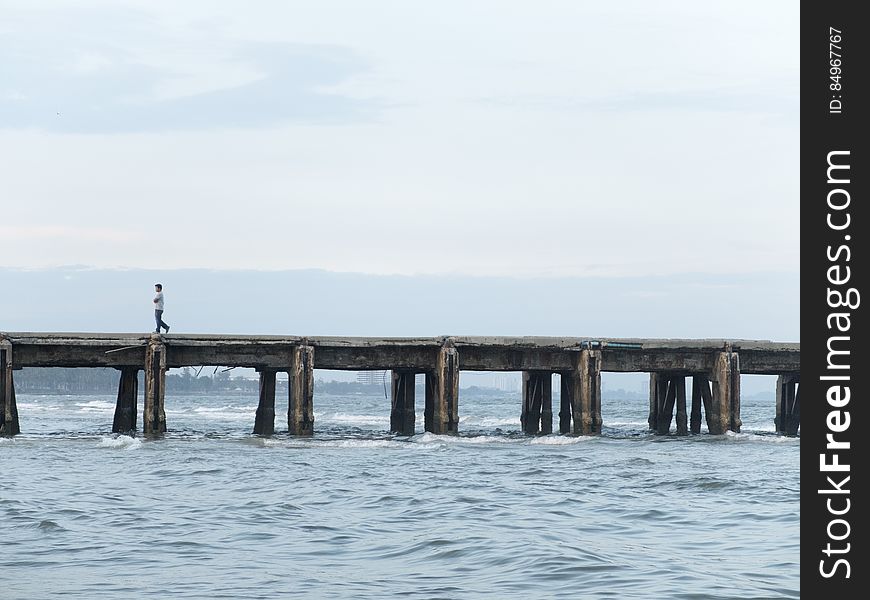 Person Walking On Ocean Pier