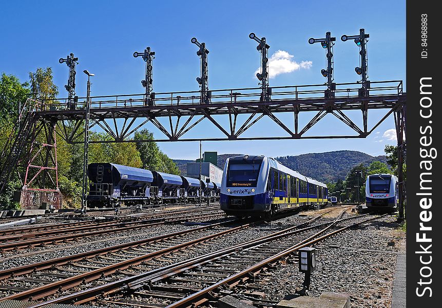 A view of a train yard with trains on the tracks.