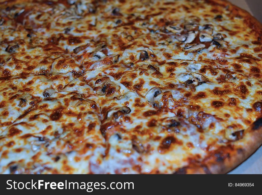 A close up of a pizza with cheese on top. A close up of a pizza with cheese on top.