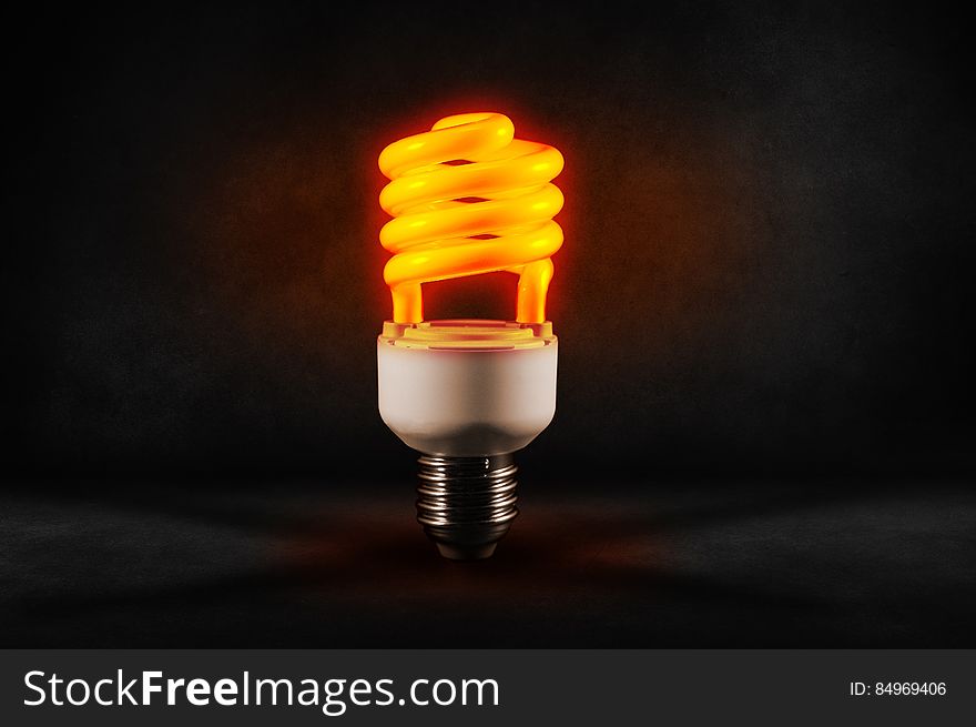 A close up of a glowing energy saving light bulb.