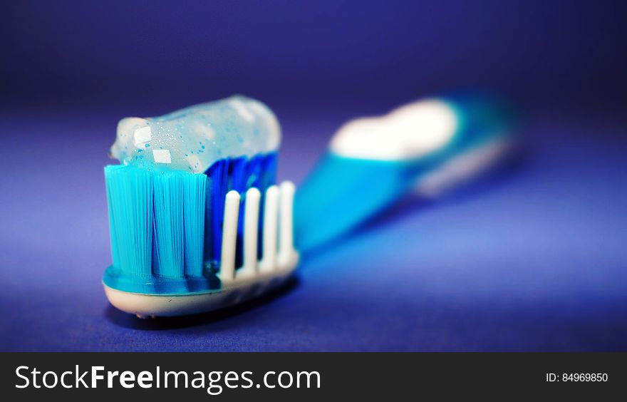 A close up shot of toothpaste on a toothbrush. A close up shot of toothpaste on a toothbrush.