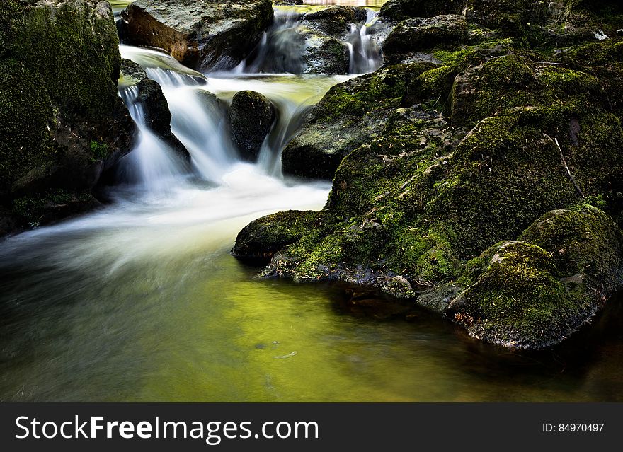 Water Fall Near Rock During Day Time