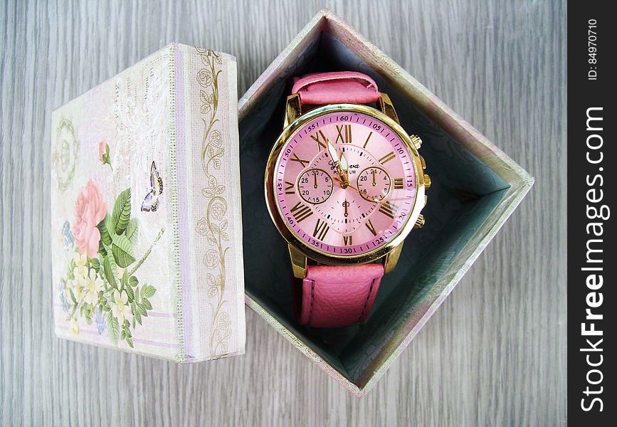 Overhead view of analogue ladies wristwatch in opened gift, box. Overhead view of analogue ladies wristwatch in opened gift, box.