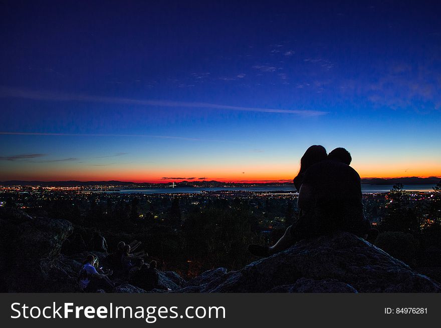 Silhouette Of Couple Holding Each Other At Sunset
