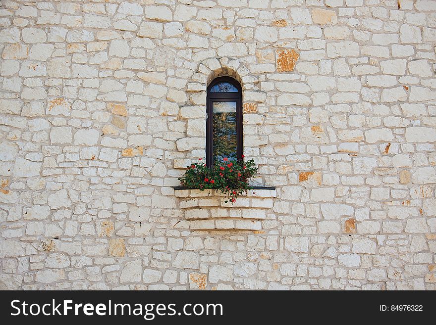 White Stone Wall With Flower Box In Window