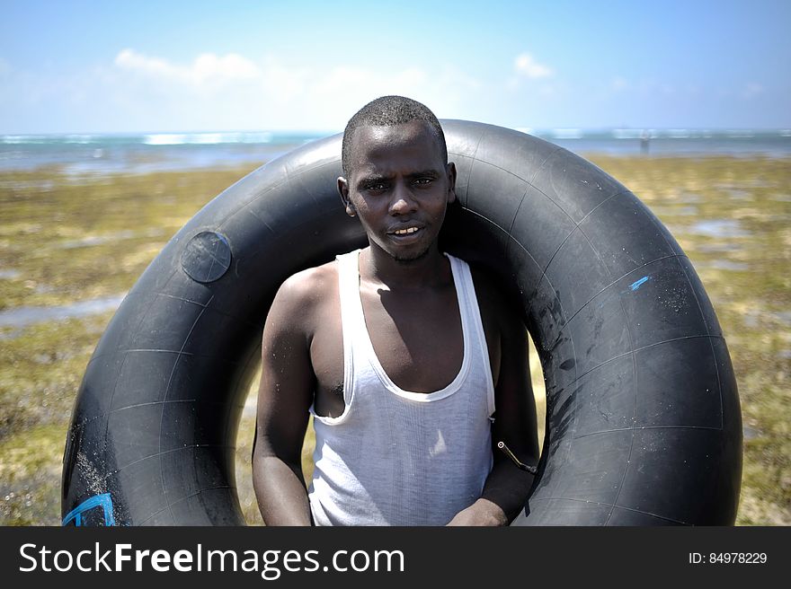 A young man poses with an old inner tube on a sand bank off of Lido beach in the Somali capital of Mogadishu on January 31. The Mogadishu lifeguards, consisting entirely of a volunteer force of fisherman, began patrolling Lido beach in September 2013 after a spate of drownings. Mogadishu&#x27;s beaches have become a popular destination for the city&#x27;s residents since al Shabab withdrew the majority of its militants from the city in 2011. AU UN IST PHOTO / Tobin Jones. A young man poses with an old inner tube on a sand bank off of Lido beach in the Somali capital of Mogadishu on January 31. The Mogadishu lifeguards, consisting entirely of a volunteer force of fisherman, began patrolling Lido beach in September 2013 after a spate of drownings. Mogadishu&#x27;s beaches have become a popular destination for the city&#x27;s residents since al Shabab withdrew the majority of its militants from the city in 2011. AU UN IST PHOTO / Tobin Jones