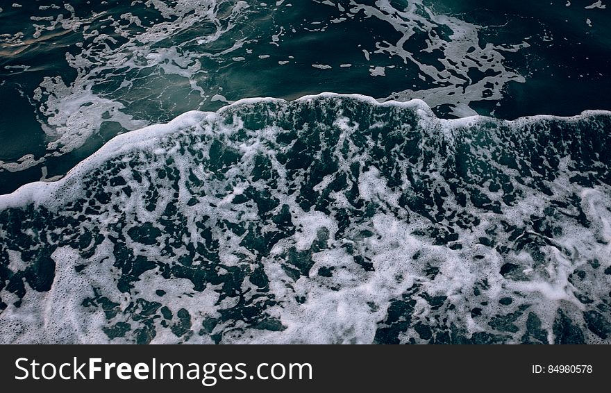 Frothy Waves In Ocean Water