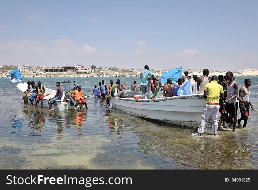 Residents of Mogadishu stand around Lido beache&#x27;s lifeboats on a sandbank in Somalia on January 31. The Mogadishu lifeguards, consisting entirely of a volunteer force of fisherman, began patrolling Lido beach in September 2013 after a spate of drownings. Mogadishu&#x27;s beaches have become a popular destination for the city&#x27;s residents since al Shabab withdrew the majority of its militants from the city in 2011. AU UN IST PHOTO / Tobin Jones. Residents of Mogadishu stand around Lido beache&#x27;s lifeboats on a sandbank in Somalia on January 31. The Mogadishu lifeguards, consisting entirely of a volunteer force of fisherman, began patrolling Lido beach in September 2013 after a spate of drownings. Mogadishu&#x27;s beaches have become a popular destination for the city&#x27;s residents since al Shabab withdrew the majority of its militants from the city in 2011. AU UN IST PHOTO / Tobin Jones