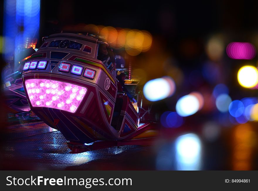 Black and Pink Speed Vehicle With Lights on Background