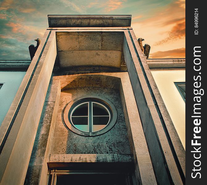 A round window in stone on a historic building. A round window in stone on a historic building.