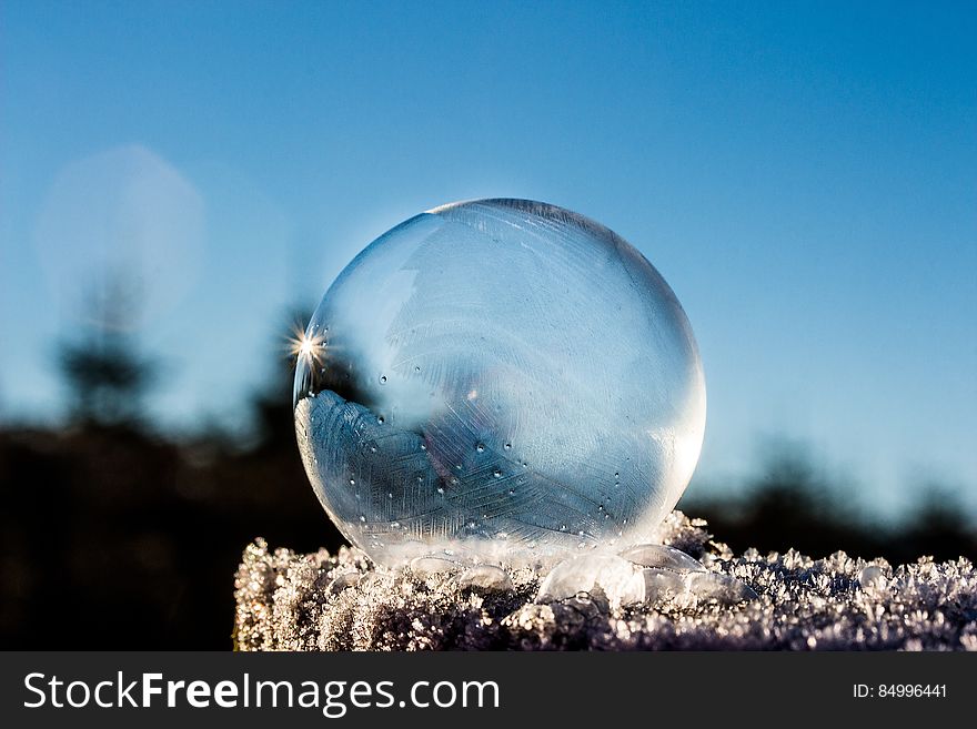 A frozen soap bubble out in the snow.