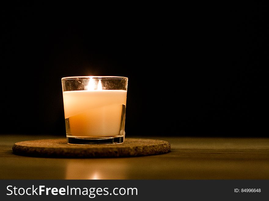A candle in a glass on the table. A candle in a glass on the table.