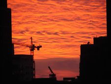 Construction Cranes Against A Fiery Sunset Stock Image Construction Cranes Against A Fiery Sunset Stock Image