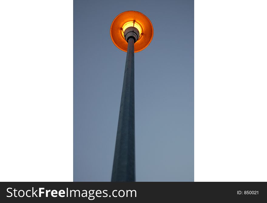 A lamp post/street light at dusk