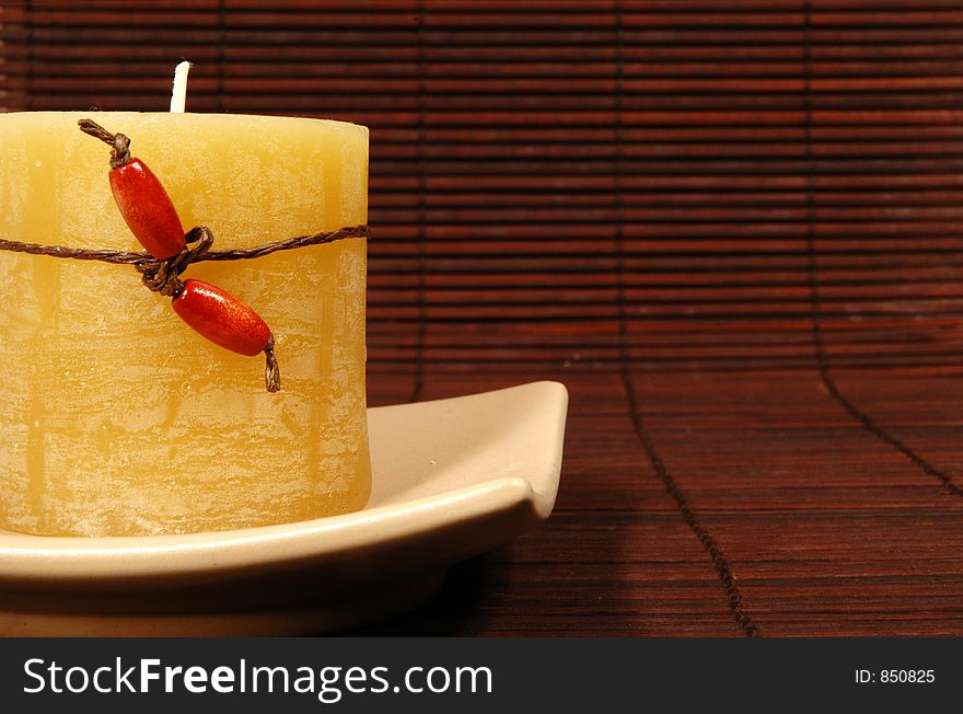 Candle on brown mat