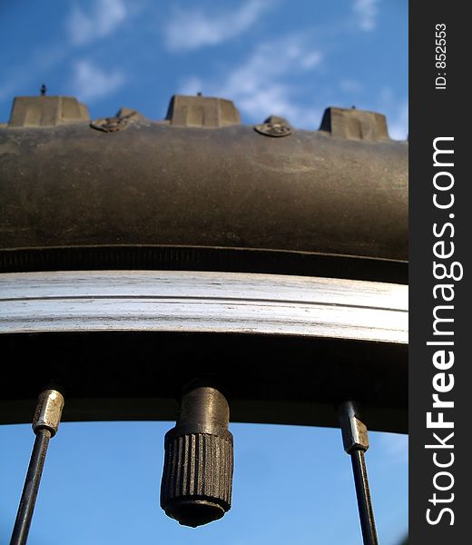 Bicycle air intake against some blue sky and clouds.  Shallow depth of field.  Focus on the intake, the tire it self begins to go out of focus near the top. Bicycle air intake against some blue sky and clouds.  Shallow depth of field.  Focus on the intake, the tire it self begins to go out of focus near the top.