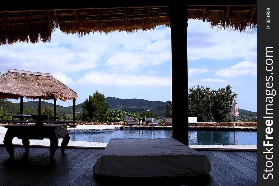 View of a shaded pool pavilion from inside. View of a shaded pool pavilion from inside