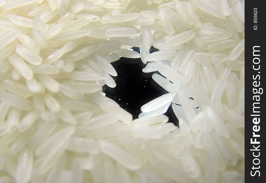 Picture of grains of rice on a mirror. rice is thailand or siamese. Picture of grains of rice on a mirror. rice is thailand or siamese