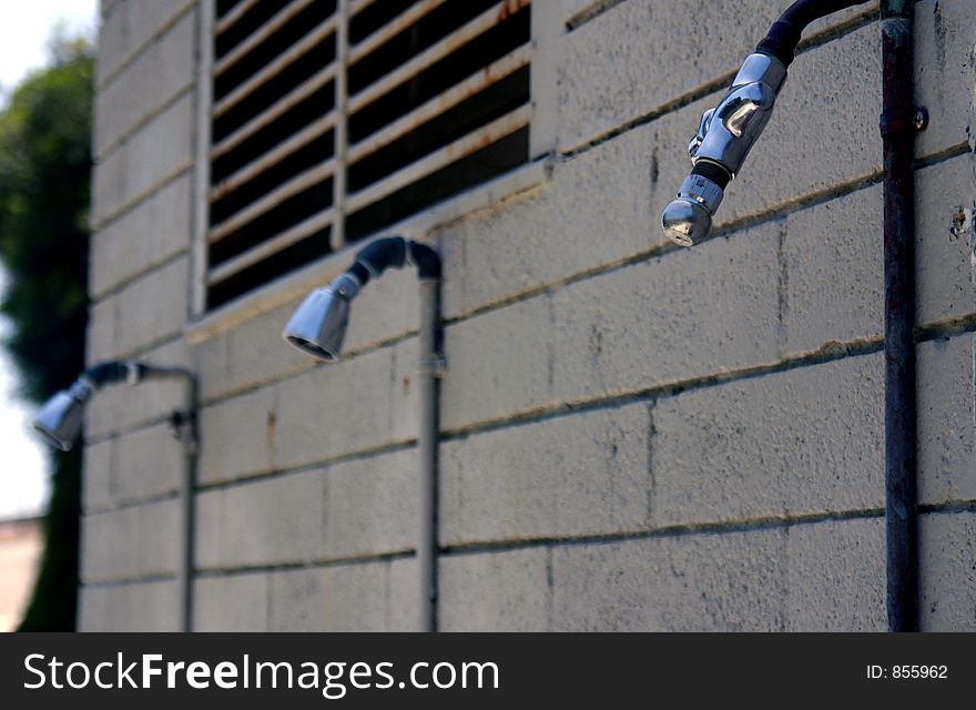 Three outdoor showers against a wall. Three outdoor showers against a wall