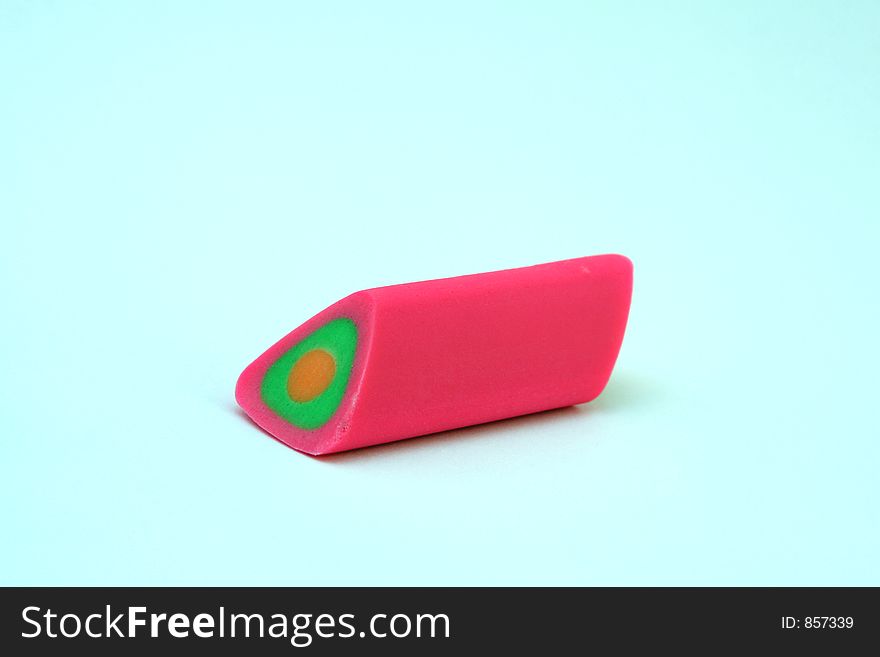 A colorful eraser, macro close up with copy space isolated on a white background. A colorful eraser, macro close up with copy space isolated on a white background.