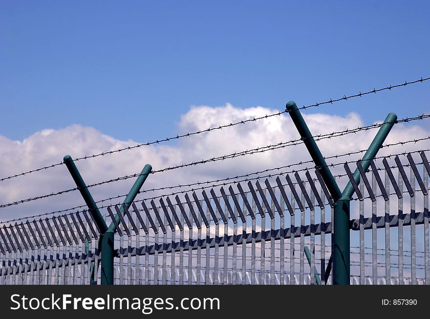 Barbed wire against a background of clouds.
