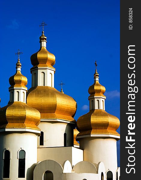 Golden Ukrainian Church roofs with deep blue sky. Golden Ukrainian Church roofs with deep blue sky