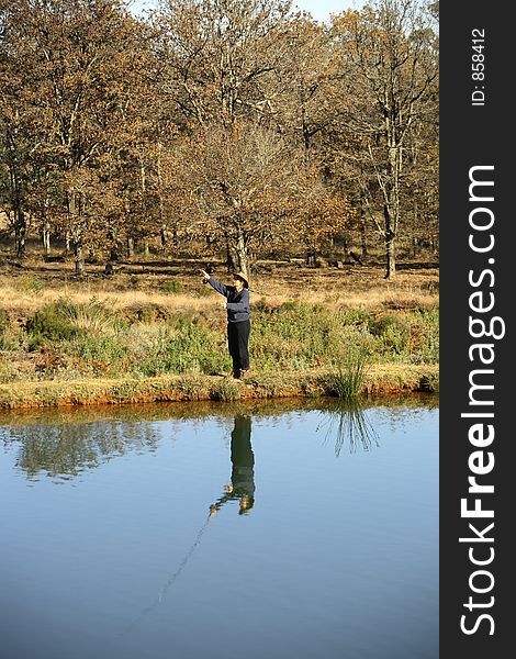 Lady casting a fly rod. Lady casting a fly rod.