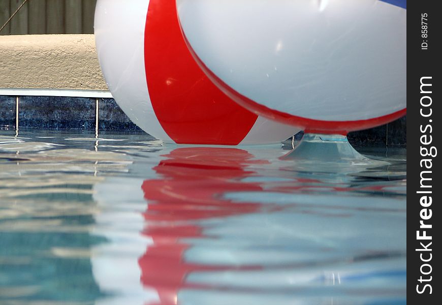 Shot of two beach balls in a pool. Shot of two beach balls in a pool.
