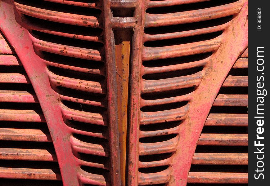 Grillework on the front of a red vintage truck. Grillework on the front of a red vintage truck.