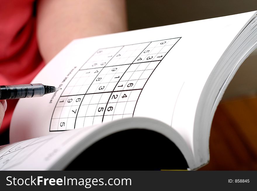 Woman figuring out a sudoku puzzle