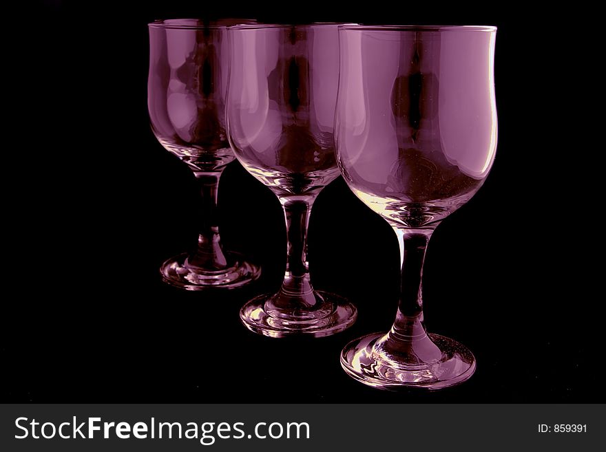 Pink wine glasses isolated on black background. Pink wine glasses isolated on black background