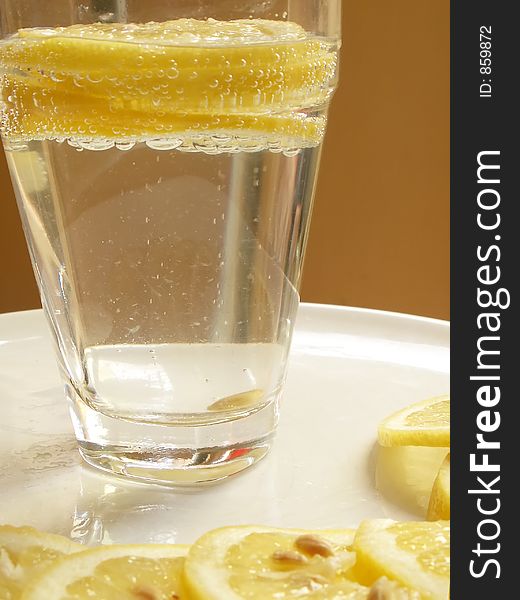 Lemon slices and glass of water. Lemon slices and glass of water