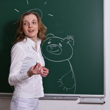 Young Woman Is Drawing On Blackboard. Royalty Free Stock Image Young Woman Is Drawing On Blackboard. Royalty Free Stock Image