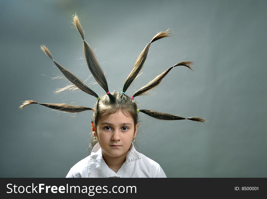 Little girl portrait with six hair plaits rised up. Little girl portrait with six hair plaits rised up