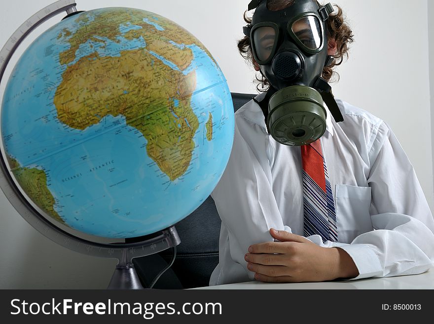 Businessman with gas mask on face looking at earth globe. Businessman with gas mask on face looking at earth globe