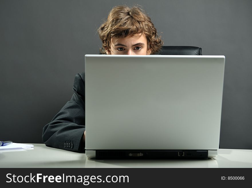 Young businessman at desk using computer laptop. Young businessman at desk using computer laptop