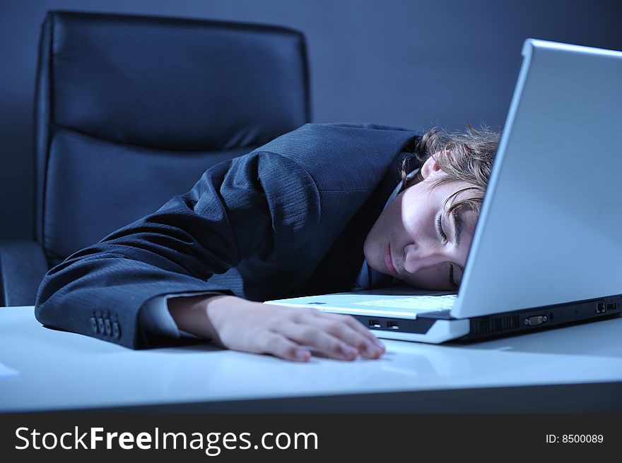 Businessman sleeping on desk near by computer laptop. Businessman sleeping on desk near by computer laptop