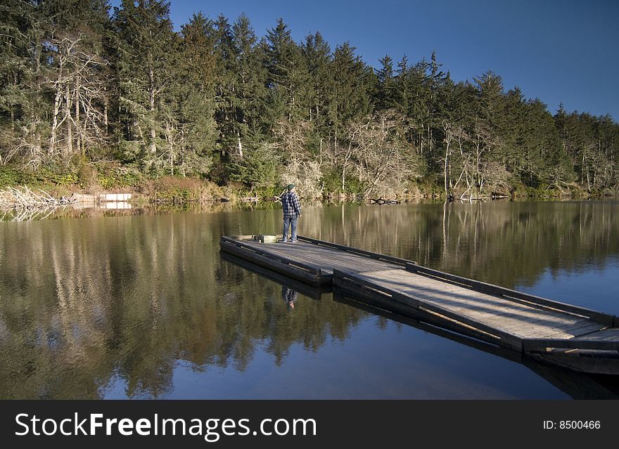 A fisherman at Oregon's Coffenbury Lake pauses to survey the scenery. A fisherman at Oregon's Coffenbury Lake pauses to survey the scenery
