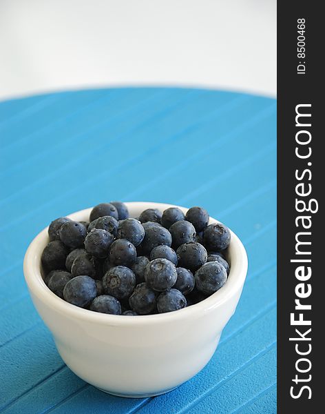 Blueberries In White Bowl Over Blue