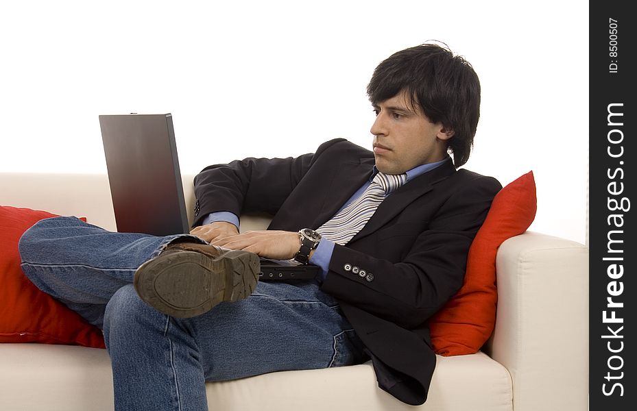 Casual young man on a sofa with laptop. Casual young man on a sofa with laptop