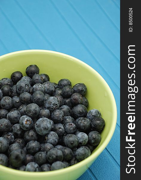 Blueberries In Green Bowl Over Blue