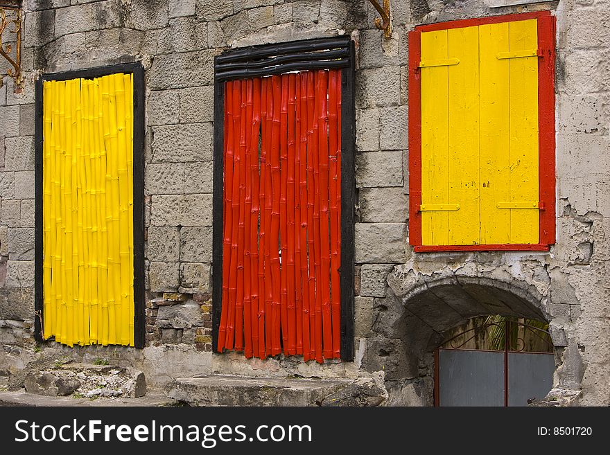 Yellow and red Windows against a wall. Yellow and red Windows against a wall
