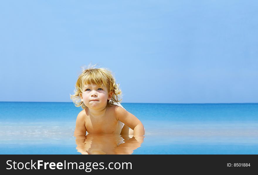 Portrait of nice baby in shallow tropic water. Portrait of nice baby in shallow tropic water