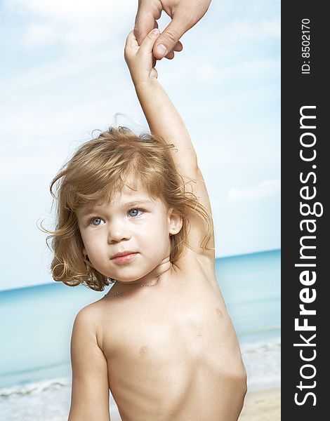 Portrait of nice little girl led by finger around the beach. Portrait of nice little girl led by finger around the beach