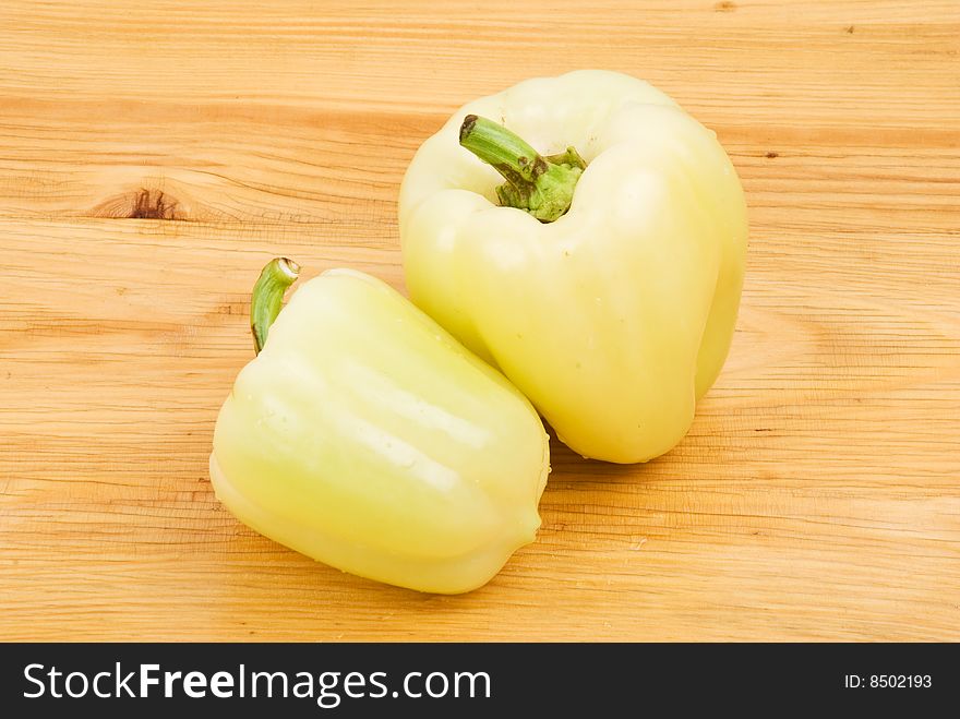 Two green light capsicum on a wood table,check also <a href=http://www.dreamstime.com/healthy-food-rcollection8217-resi828293>Healthy food</a>