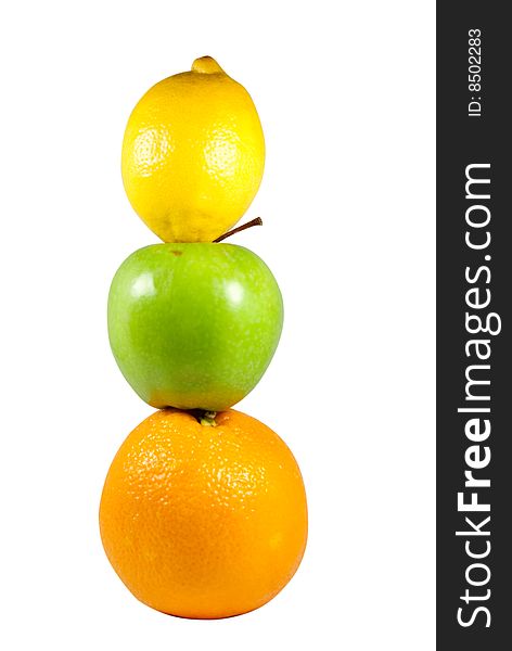 A lemon on an apple on an orange. A lemon on an apple on an orange