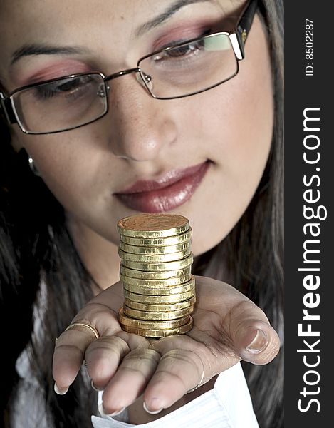 Girl with gold coins in studio.